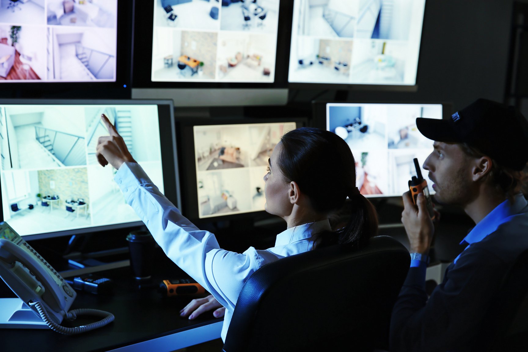 Security Guards Monitoring Modern CCTV Cameras in Surveillance Room